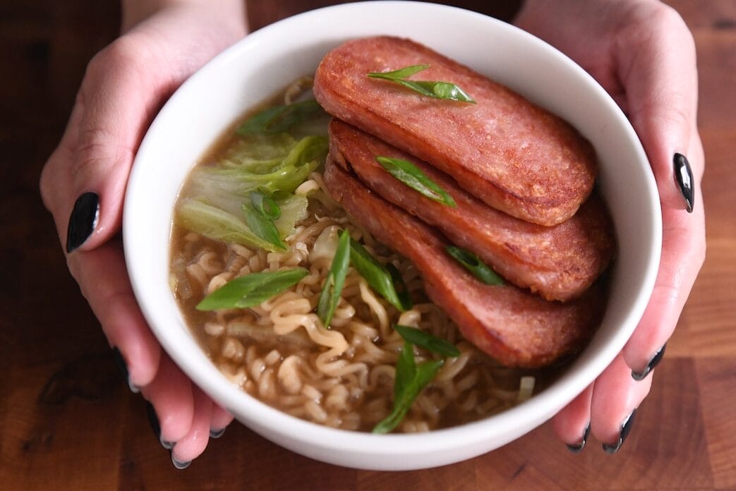 bowl of instant noodles topped with spam and green onions