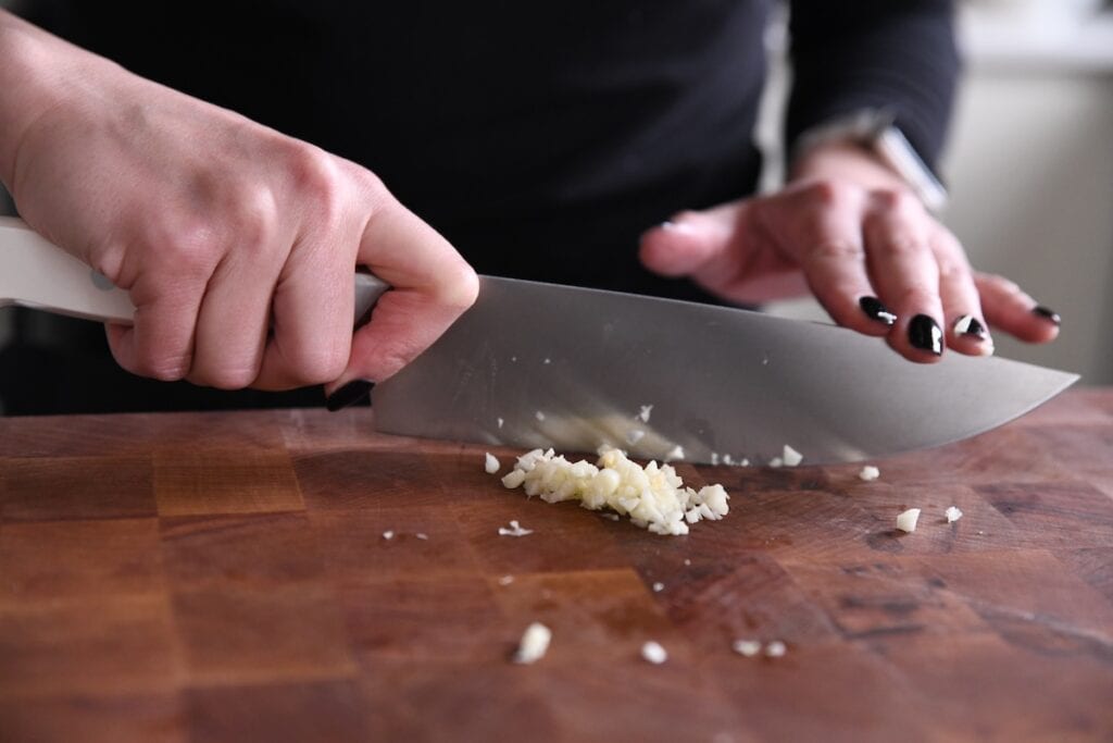 mincing garlic with knife