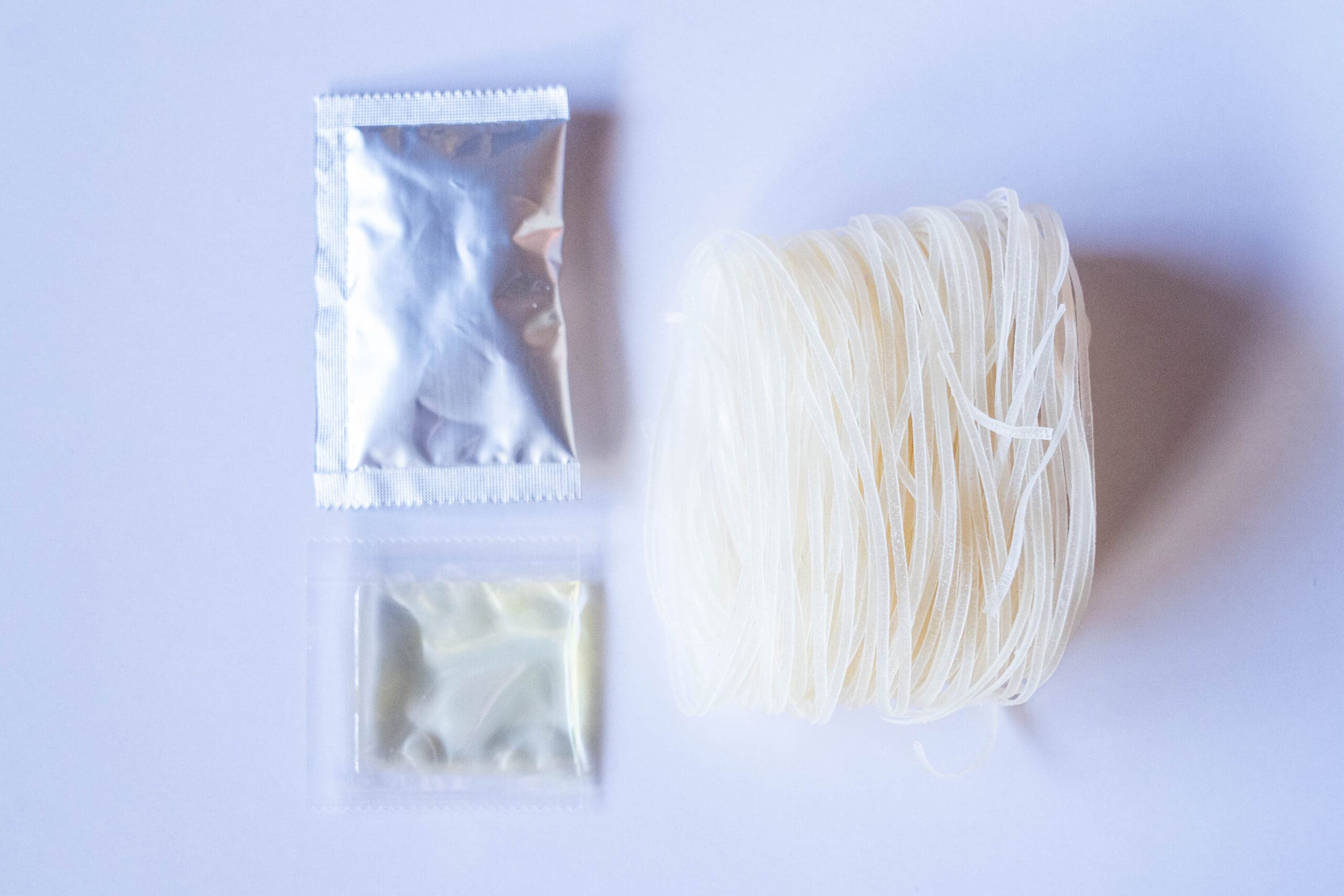 Soup base, oil, and rice noodle serving