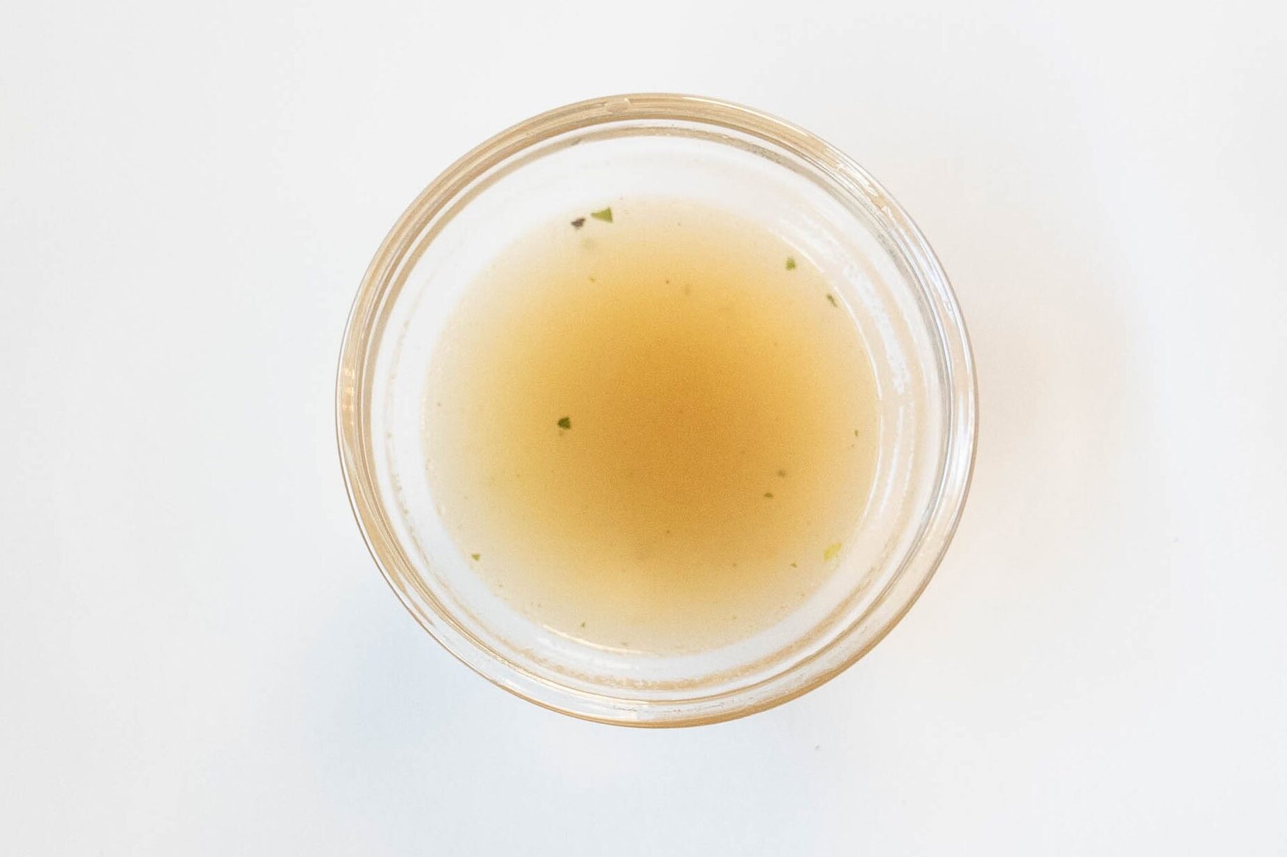 Koka Pepper Crab Noodles broth in a glass ramekin showing golden color