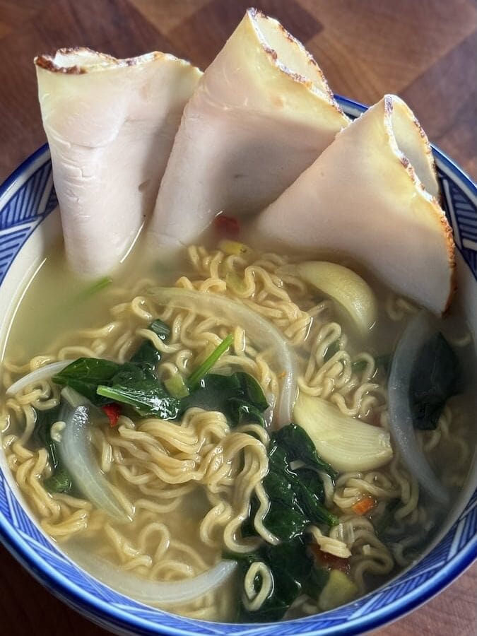 deli turkey slice sin a bowl with ramen nooodles