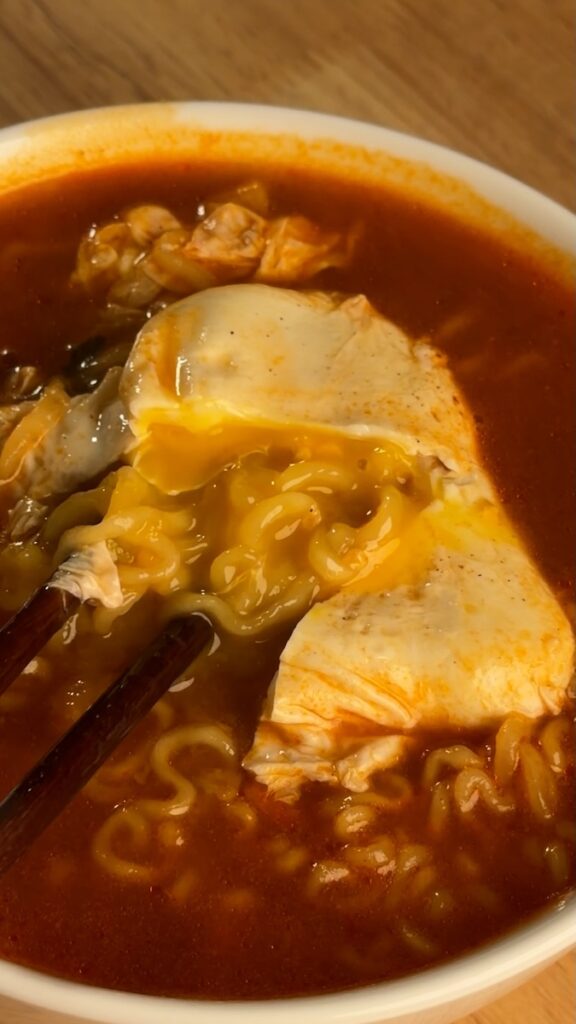 runny egg yolk on top of noodles
