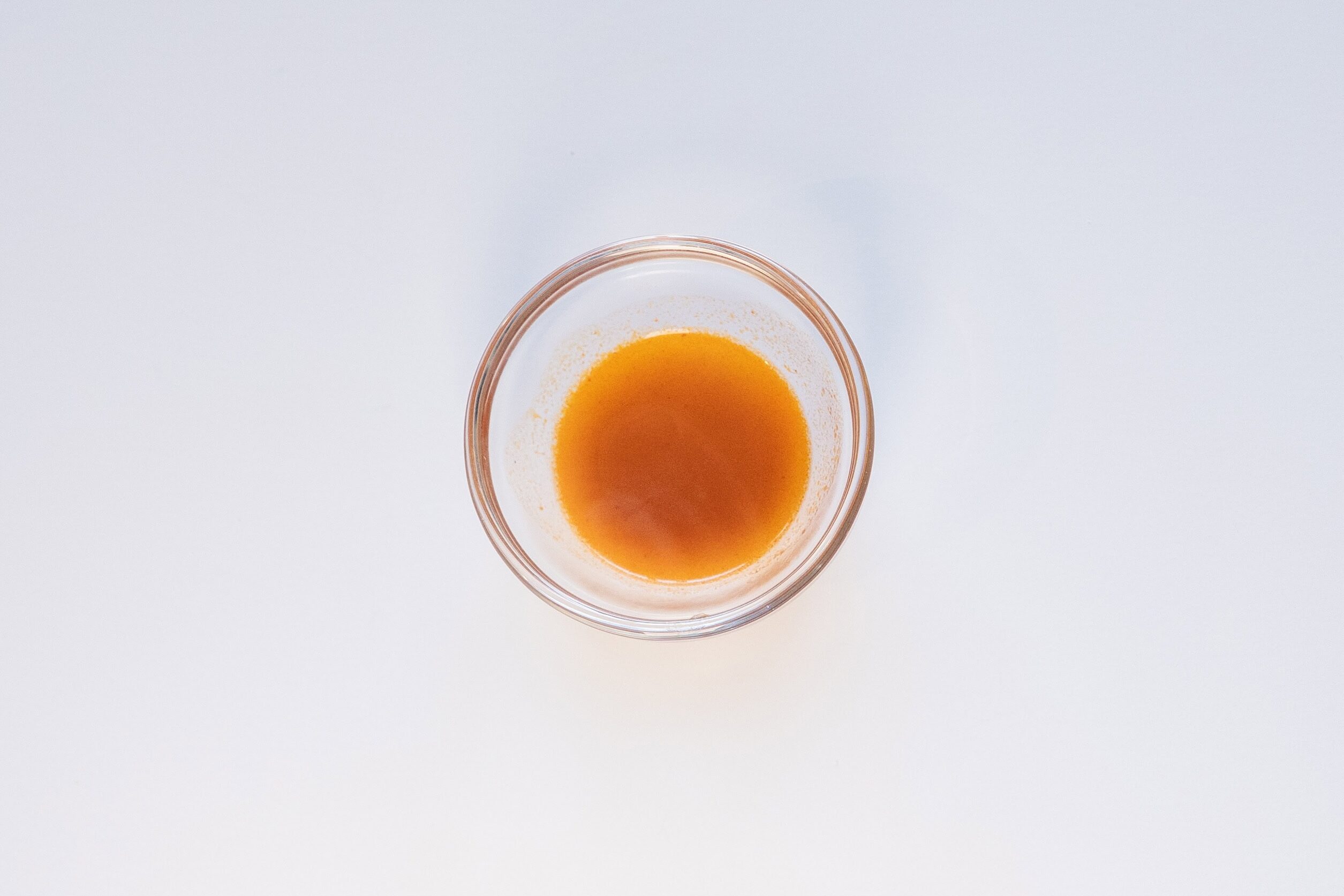Nongshim Shin Ramyun Tom Yum Flavor Jay Fai broth in a glass ramekin
