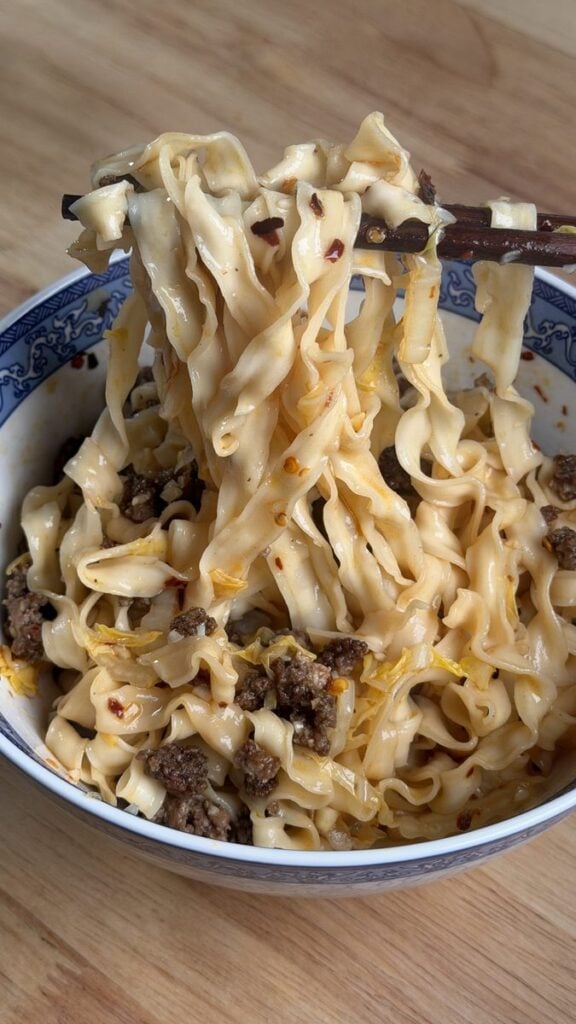 Bowl of easy chili oil noodles topped with ground beef