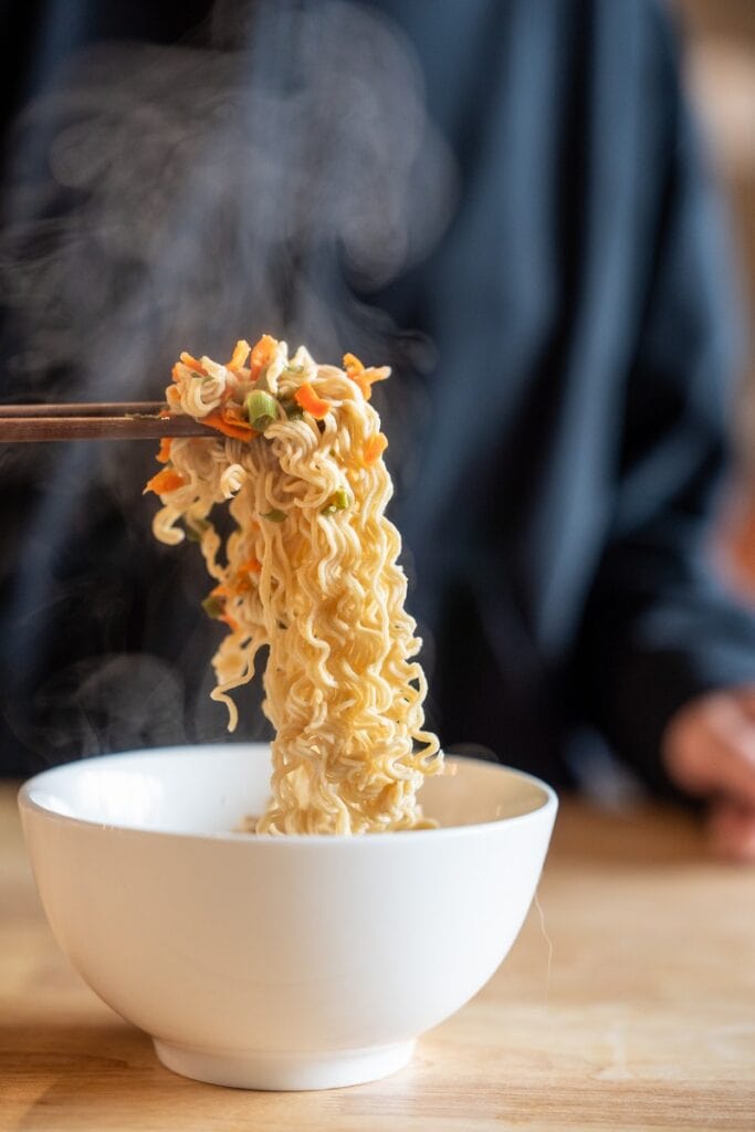 Heal Spot High Protein Instant Ramen Classic Ramen Flavor noodles being pull with wooden chopsticks