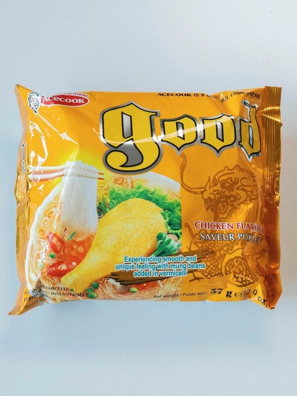 The golden yellow package of Acecook Good Chicken Vermicelli on a white surface, showing the red Acecook logo at the top, the large yellow Gothic "good" logo, CHICKEN FLAVOUR / SAVEUR POULET in red, a photo of the finished clear vermicelli soup with greens and chili, and small text reading "Experiencing smooth and unique feeling with mung beans added in vermicelli".