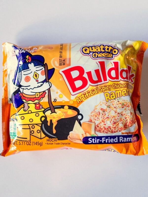 Package of Samyang Buldak Quattro Cheese Spicy Chicken Stir-Fried Ramen on a white background