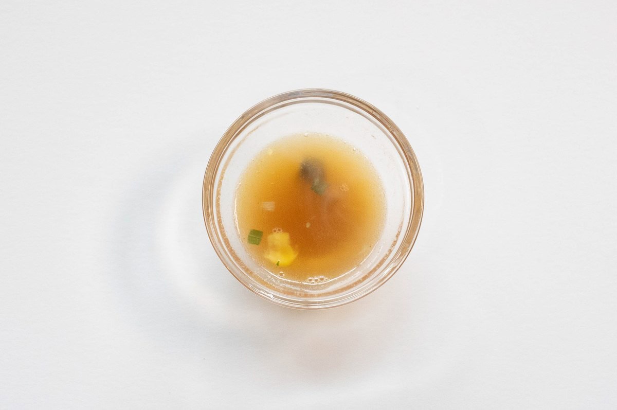 Nissin Cup Noodles Crab Flavor (Hong Kong) broth in a glass ramekin showing golden color
