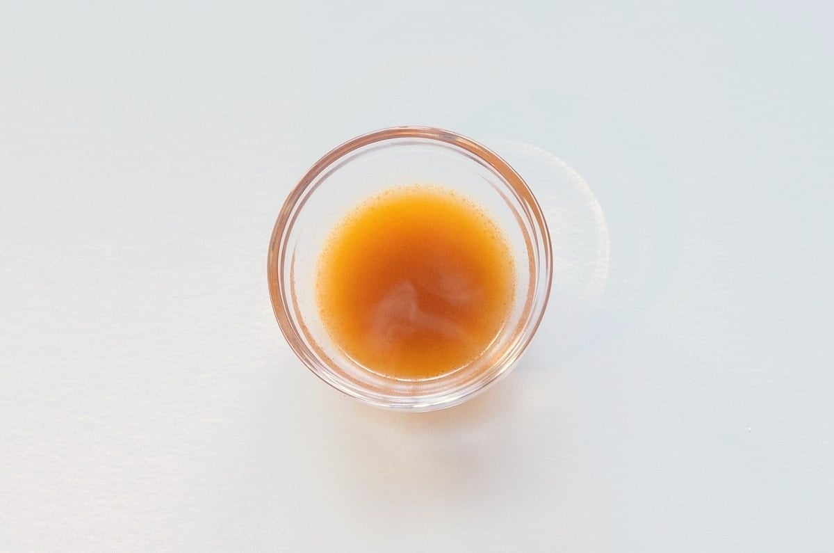 Nongshim Shin Ramyun Spicy Noodle Soup broth in a glass ramekin showing golden color